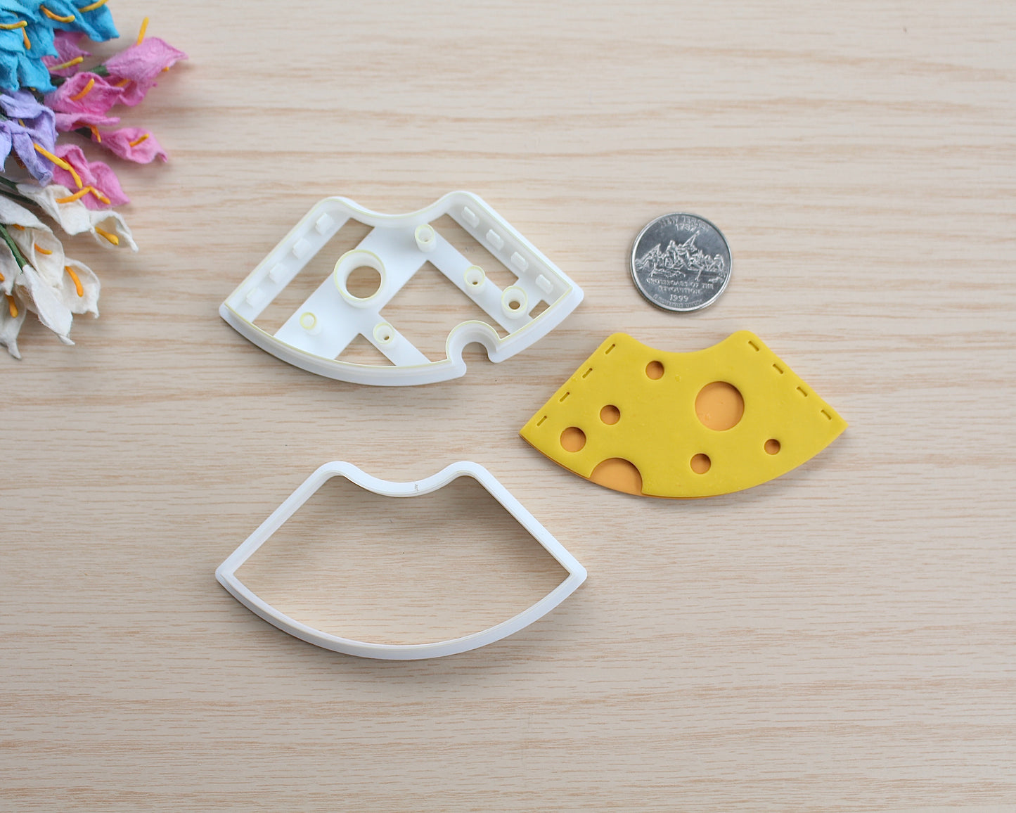 Swiss Cheese Corner Bookmark Polymer Clay Cutter shaped like a slice of cheese with holes, designed for making polymer clay bookmarks