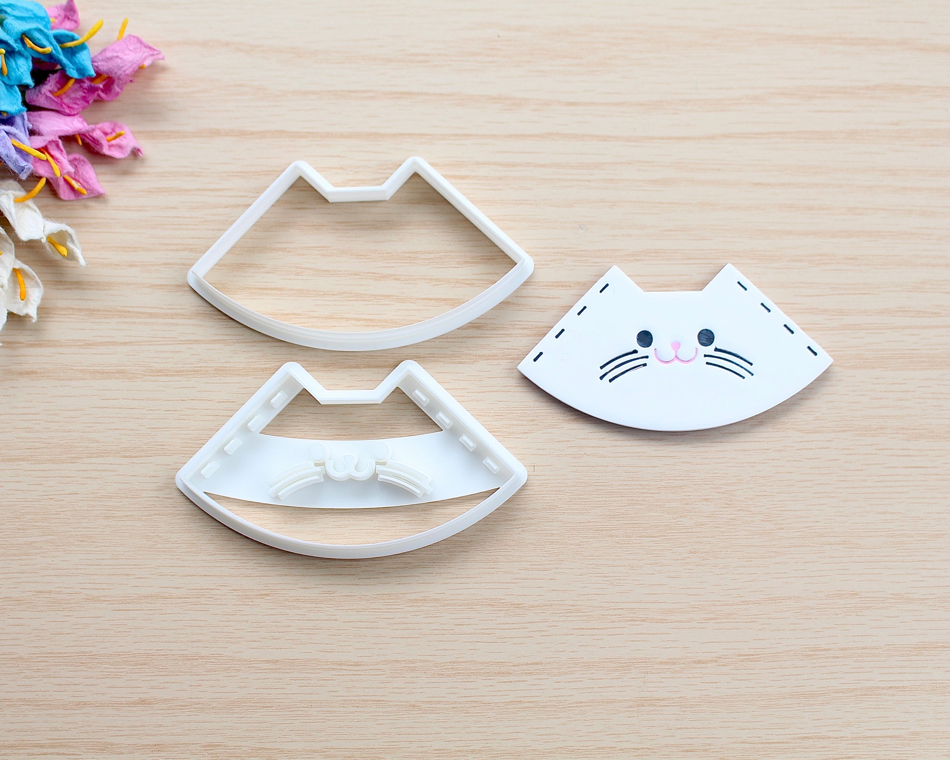 Kitty Corner Bookmark Polymer Clay Cutter in the shape of a cat’s face, designed for making polymer clay bookmarks.